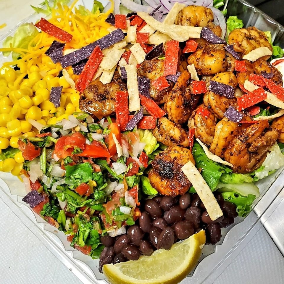 Tatersaladz's healthy salad with grilled shrimp, corn, black beans, pico de gallo, cheese, and tortilla strips.